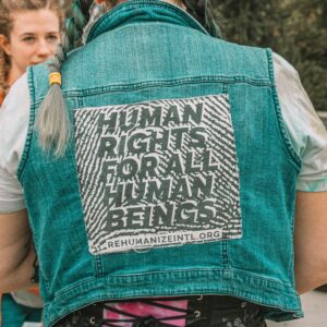 man wearing a jacket that says human rights for all human beings